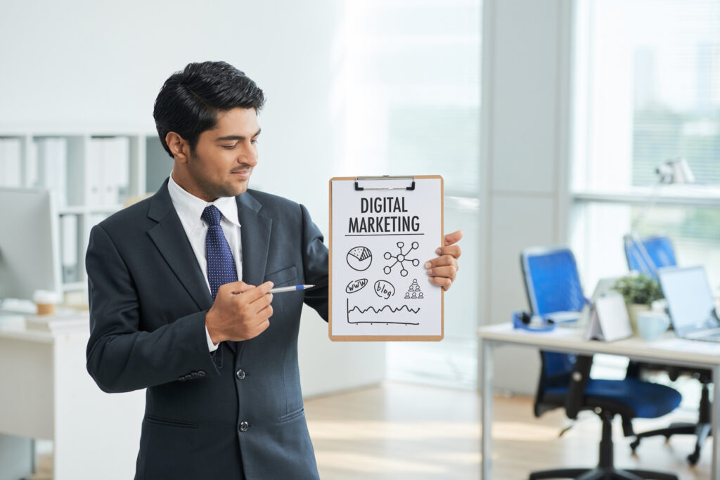 man suit standing office with clipboard pointing poster with words